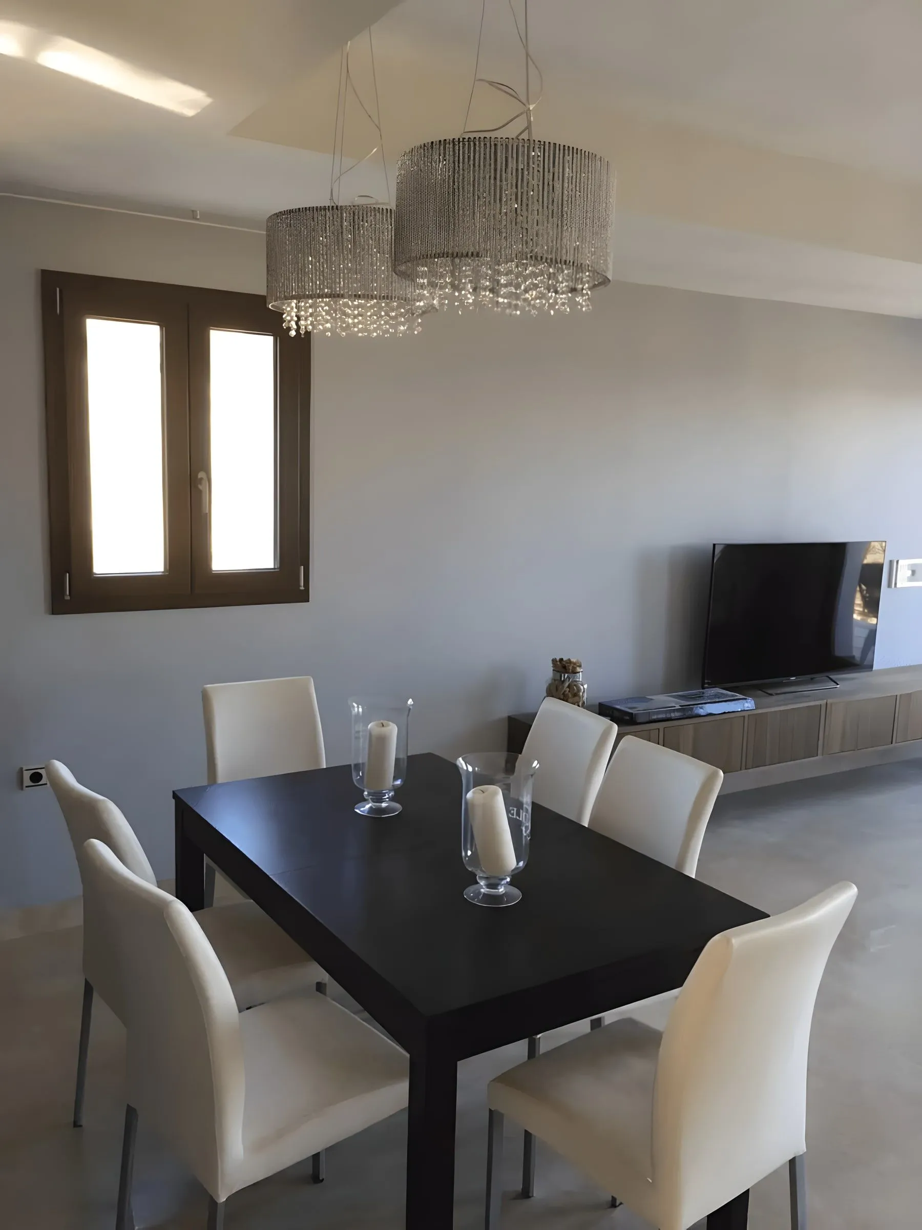 Dining area with dark table and upholstered chairs