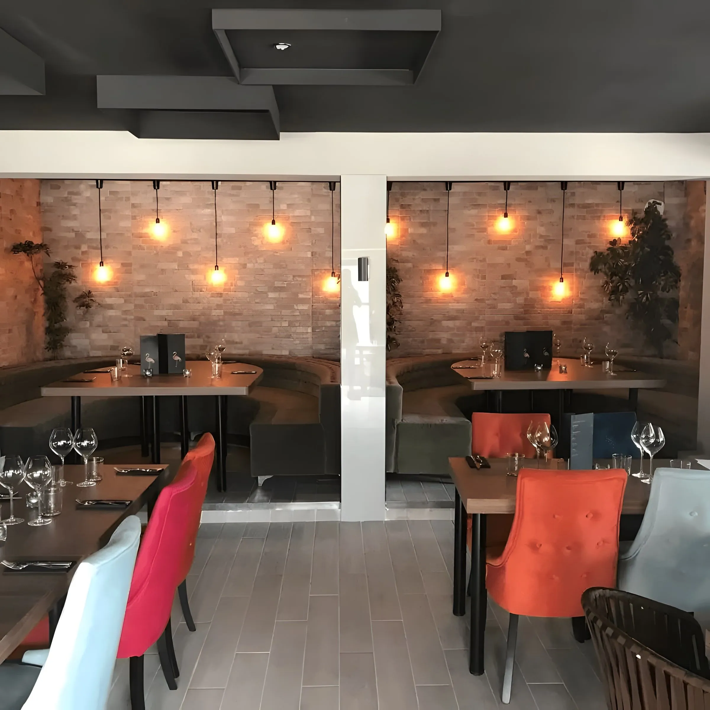 Private booths in a renovated restaurant with colourful chairs